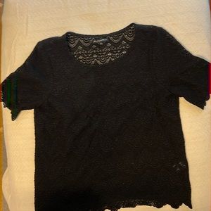 Black lace short sleeve shirt with scalloped trim.